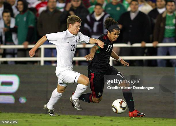 Giovani Dos Santos of Mexico paces the ball on the left wing against Michael McGlinchey of New Zealand in the second half during their International...