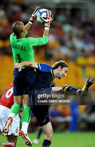 Indonesian goalkeeper Markus Rihihina takes the ball over Australia's Josh Kennedy during their Asian Cup 2011 football qualification match in...