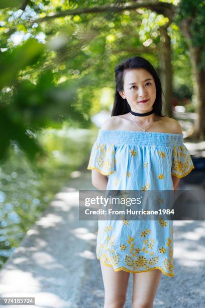 one young lady enjoying sunny summer vacation by boden lake - boden stock pictures, royalty-free photos & images