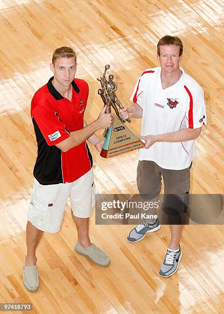 Shawn Redhage captain of the Wildcats and Mat Campbell captain of the Hawks pose with the NBL Trophy during the NBL Grand Final Series launch at...
