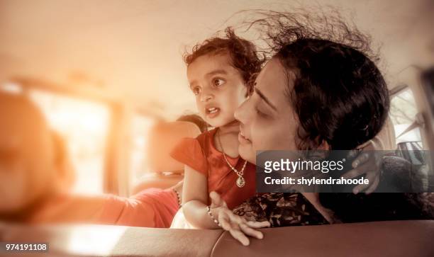 mother and daughter traveling in car - daily life in kerala stock pictures, royalty-free photos & images