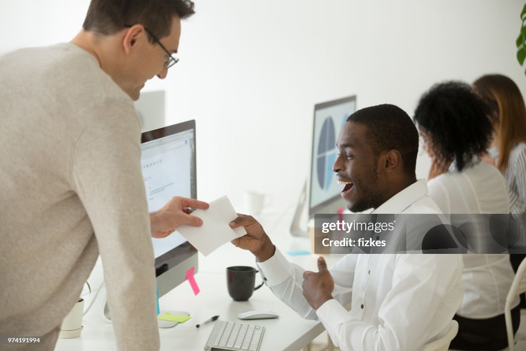 Excited black worker rewarded with money bonus for good work