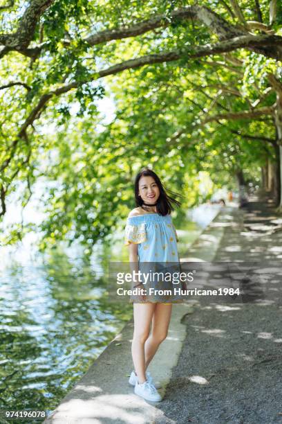 one young lady enjoying sunny summer vacation by boden lake - boden stock pictures, royalty-free photos & images