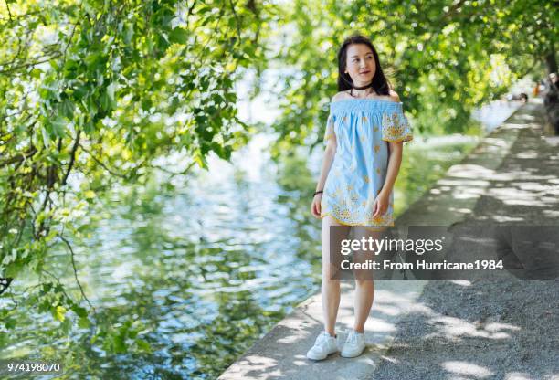 one young lady enjoying sunny summer vacation by boden lake - boden stock pictures, royalty-free photos & images