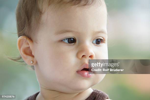 close up of hispanic baby girl - boucle d'oreille photos et images de collection