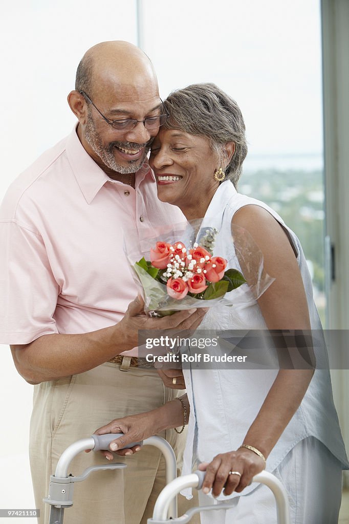 African man giving wife flowers