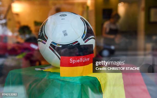 Hairdresser store in the small Bavarian village of Herrsching near Munich, southern Germany, is decorated with a football, a captain's armband and...