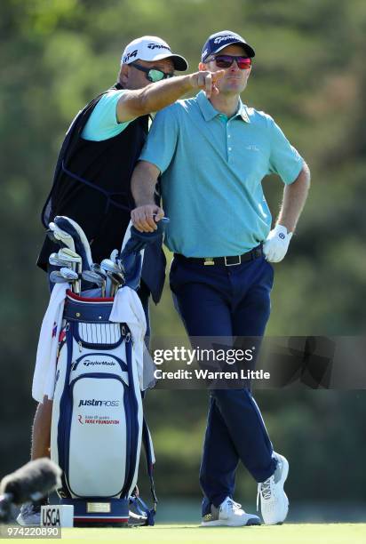 Justin Rose of England talks with caddie Mark Fulcher on the sixth tee during the first round of the 2018 U.S. Open at Shinnecock Hills Golf Club on...