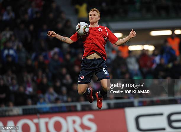 John Arne Riise of Norway stops a ball in the air during their friendly match between Slovakia and Norway in Zilina on March 03,2010. AFP PHOTO/JOE...