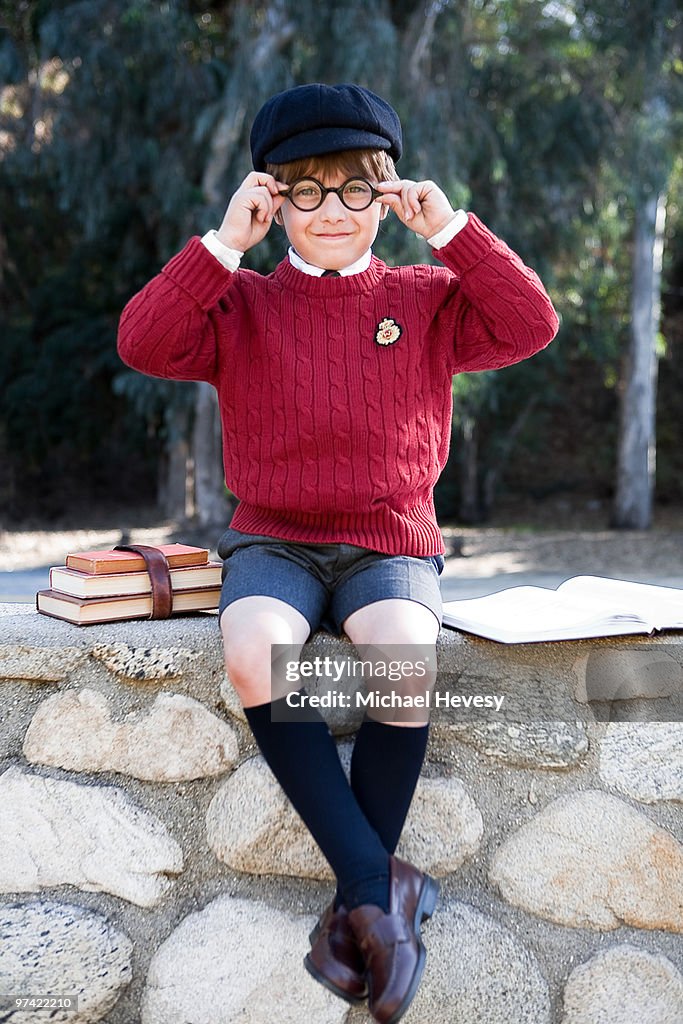 Young Prep School Student Sitting with Books