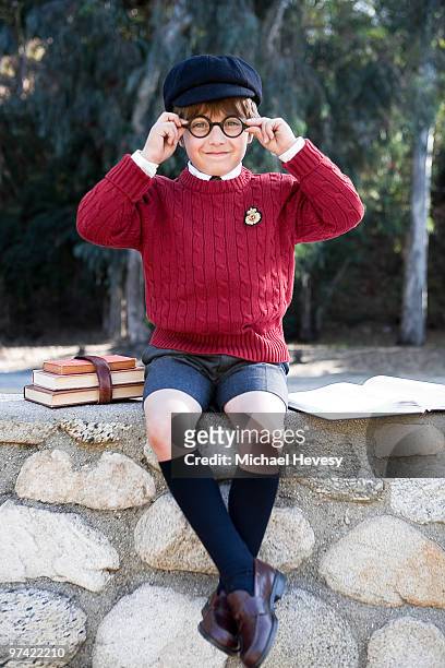 young prep school student sitting with books - knee length stock pictures, royalty-free photos & images