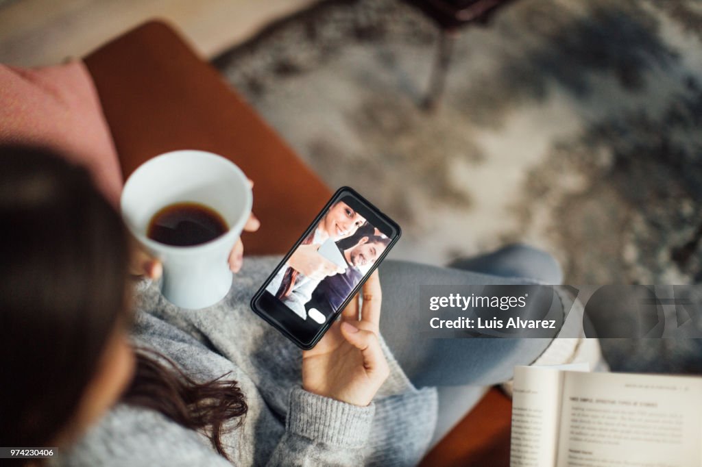 Woman taking selfie with boyfriend using smart phone