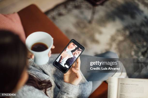 woman taking selfie with boyfriend using smart phone - holding coffee stock pictures, royalty-free photos & images