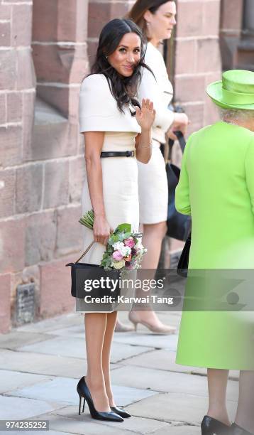 Meghan, Duchess of Sussex waves as she departs Chester Town Hall, where the Duchess and Queen Elizabeth II attended lunch as guests of Chester City...