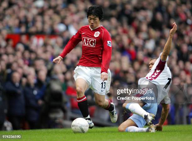 Wilfred Bouma of Aston Villa tackles Ji Sung Park of Manchester United during the FA Cup 3rd Round match between Manchester United and Aston Villa at...