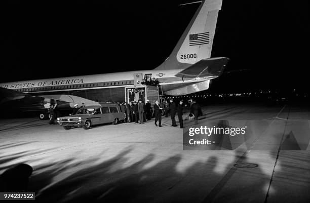 Navy ambulance containing the body of slain President John Fitzgerald Kennedy, assassinated in Dallas, waits near the Air Force One plane from which...