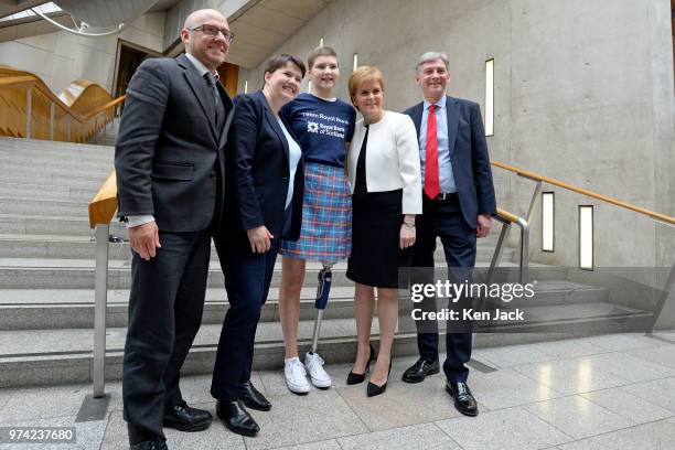 Scottish party leaders Patrick Harvie, Ruth Davidson, Nicola Sturgeon, and Richard Leonard in the lobby of the Scottish Parliament with 17-year-old...