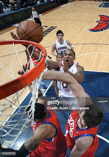 Jeff Teague of the Atlanta Hawks puts up a shot over Jason Smith of the Philadelphia 76ers on February 28, 2010 at Philips Arena in Atlanta, Georgia....