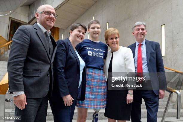 Scottish party leaders Patrick Harvie, Ruth Davidson, Nicola Sturgeon, and Richard Leonard in the lobby of the Scottish Parliament with 17-year-old...