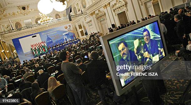 European Commission Chairman Jose Manuel Barroso is seen on a tv screen as he addresses on March 4, 2010 a meeting in Budapest of the group bureau of...