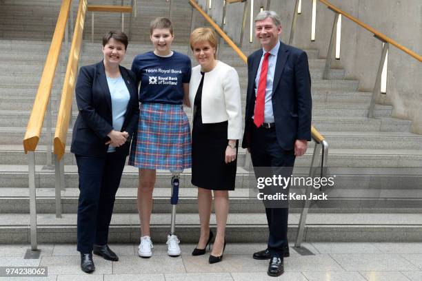 Scottish party leaders Ruth Davidson, Nicola Sturgeon, and Richard Leonard in the lobby of the Scottish Parliament with 17-year-old amputee Johanna...