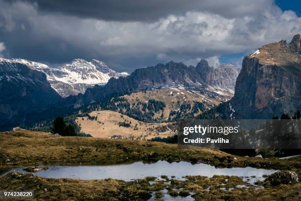 view of the high mountains of grohmannspitz with pass sella, dolomites, european alps, italy - mountain pass stock pictures, royalty-free photos & images