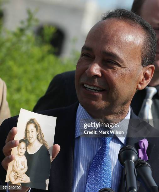 With Father's Day approaching, Rep. Luis Gutierrez holds up a picture of his daughter and grandson during a news conference to urge the Trump...