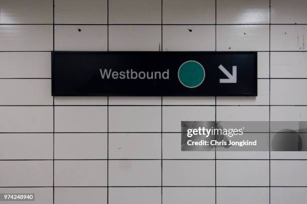 westbound sign pointing downstairs - ttc stock pictures, royalty-free photos & images