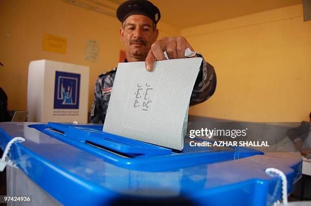 Iraqi police commando casts his vote at a polling station in the city of Ramadi west of Baghdad on March 4, 2010. Voting began in Iraq's general...