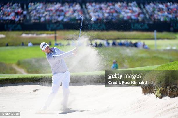 Branden Grace of South Africa plays a shot from a bunker on the 17th hole during the first round of the 2018 U.S. Open at Shinnecock Hills Golf Club...