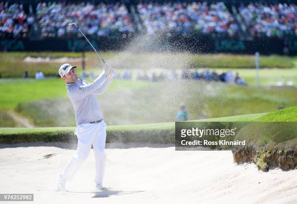 Branden Grace of South Africa plays a shot from a bunker on the 17th hole during the first round of the 2018 U.S. Open at Shinnecock Hills Golf Club...