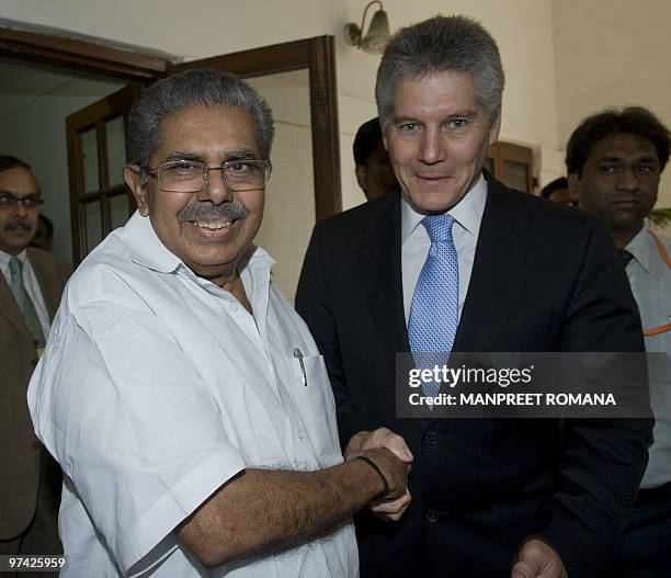 Indian Overseas Indian Affairs Minister Vayalar Ravi shakes hands with Australian Foreign Minister Stephen Smith during their meeting in New Delhi on...