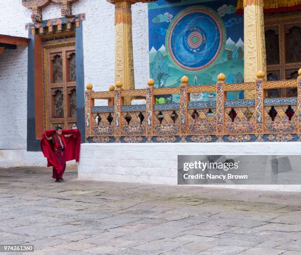 buddhist monk in punakha dzong in bhutan. - punakha dzong stock pictures, royalty-free photos & images