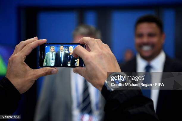 Former Brazilian player Ronaldo is pictured by a mobile phone prior to the 2018 FIFA World Cup Russia Group A match between Russia and Saudi Arabia...