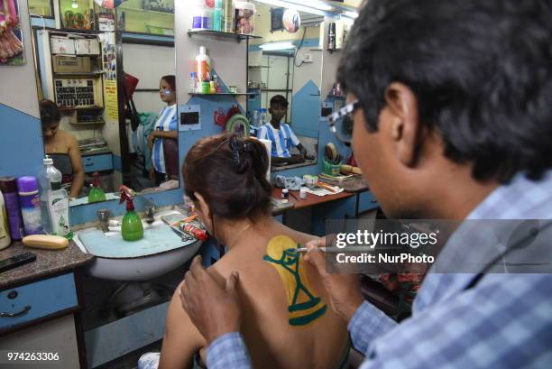 Indian Hair cutter and Artist Robin Das makes the new body panting FIFA World Cup 2018 trophy ahead of the upcoming FIFA Russia 2018 World Cup, in...