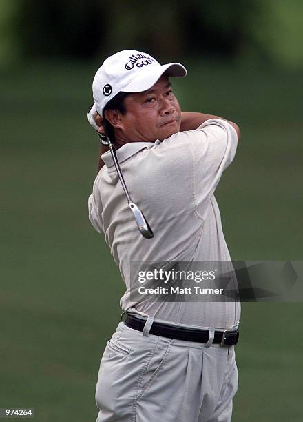 Kyi Hla Han of Myanmar plays his second shot to the 14th green during the second round of the Carlsberg Malaysian Open being held at Saujana Golf and...