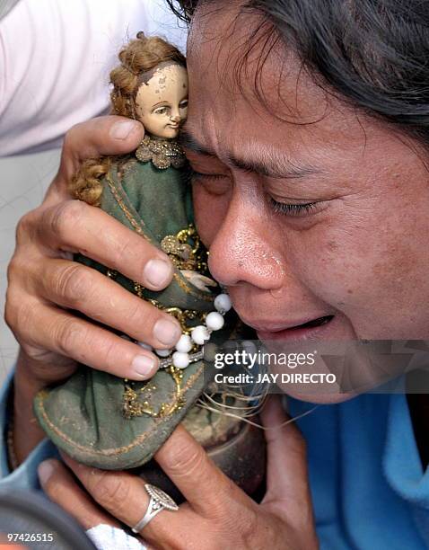 Woman cries as her house is demolished by workers of the Department of Public Work and Highways in Navotas City suburban Manila on March 4, 2010 as...