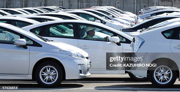 Worker drives a newly assembled Toyota Prius hybrid vehicle near the company's plant in the city of Toyota, Aichi Prefecture on March 3, 2010. US...