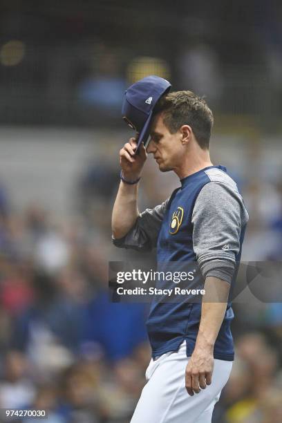 Manager Craig Counsell of the Milwaukee Brewers walks to the dugout during a game against the Chicago Cubs at Miller Park on June 11, 2018 in...