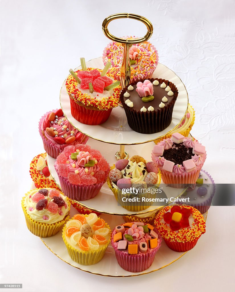 Brightly decorated cupcakes on tiered cake stand