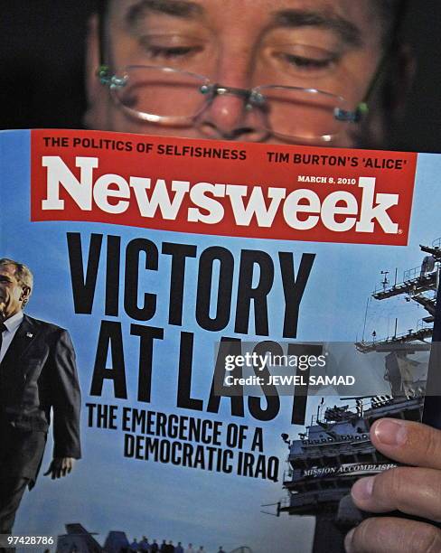 Man reads the March 8, 2010 issue of Newsweek in Washington,DC. The weekly magazine discusses former US President George W. Bush's role and the...