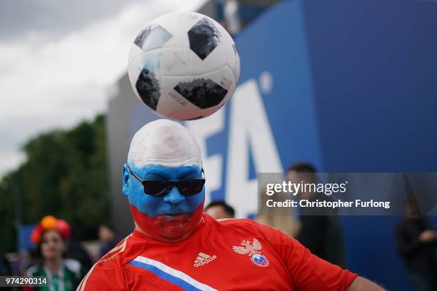 Russian fan plays football at the official FIFA Fan Fest at Moscow State University where fans will watch the first World Cup game between Russia and...