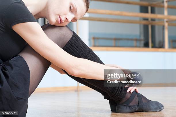 young woman sits resting in rehearsal room - leotard and tights stock pictures, royalty-free photos & images