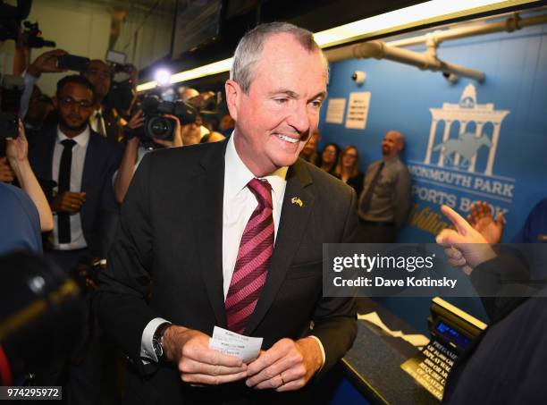 Governor of New Jersey Phil Murphy places the first bet at the William Hill Sports Book at Monmouth Park as it opens and welcomes public to place...