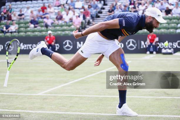 Benoit Paire of France loses his racket as he struggles during his match against Tomas Berdych of Czech Republic during day 4 of the Mercedes Cup at...