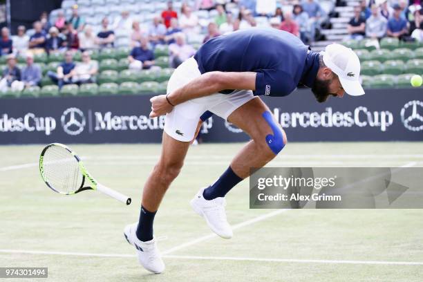 Benoit Paire of France loses his racket as he struggles during his match against Tomas Berdych of Czech Republic during day 4 of the Mercedes Cup at...