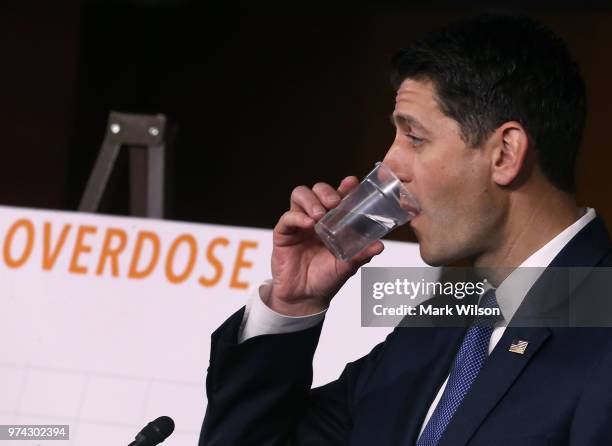 House Speaker Paul Ryan takes a drink of water while speaking about the opioid crisis during his weekly news conference on Capitol Hill, June 14,...