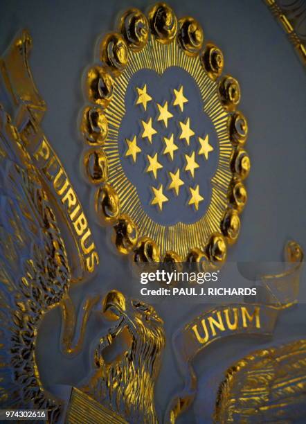 The gilded "E Pluribus Unum" symbol is seen on the ceiling of the Benjamin Franklin Room inside the US State Department on September 16, 2009 in...