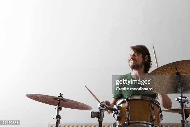 young man plays drums with enjoyment - batteur photos et images de collection