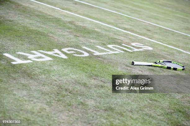 The racket of Benoit Paire of France is lying on the grass during his match against Tomas Berdych of Czech Republic during day 4 of the Mercedes Cup...
